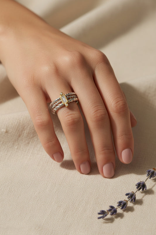 Celeste sterling silver fidget ring with three twisted bands and emerald cut stone