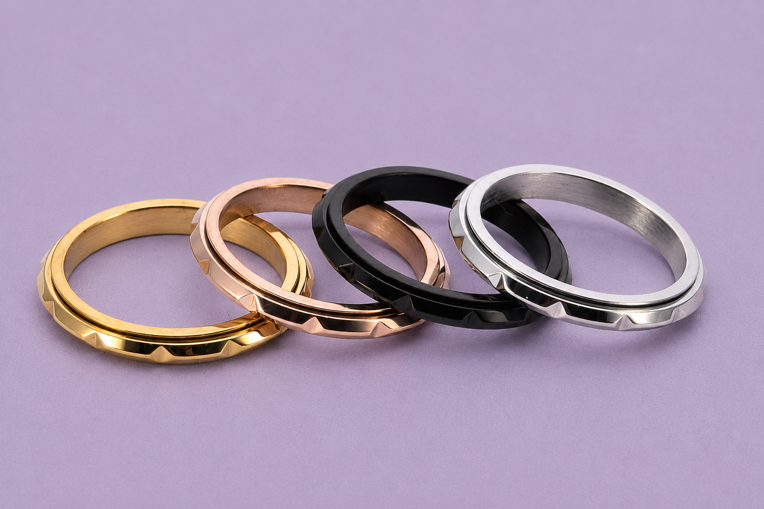 Discreet textured spinner ring shown from above on lavender linen