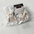 Gender neutral baby gift basket with clothing, plush panda, book, and swaddle is a Luxury newborn gift set with bear hat, bib, and bath products