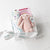 Pink new baby girl gift basket with swaddle, bunny, book, and teether, making it the perfect Bedtime snuggles gift set for newborn girls in keepsake box