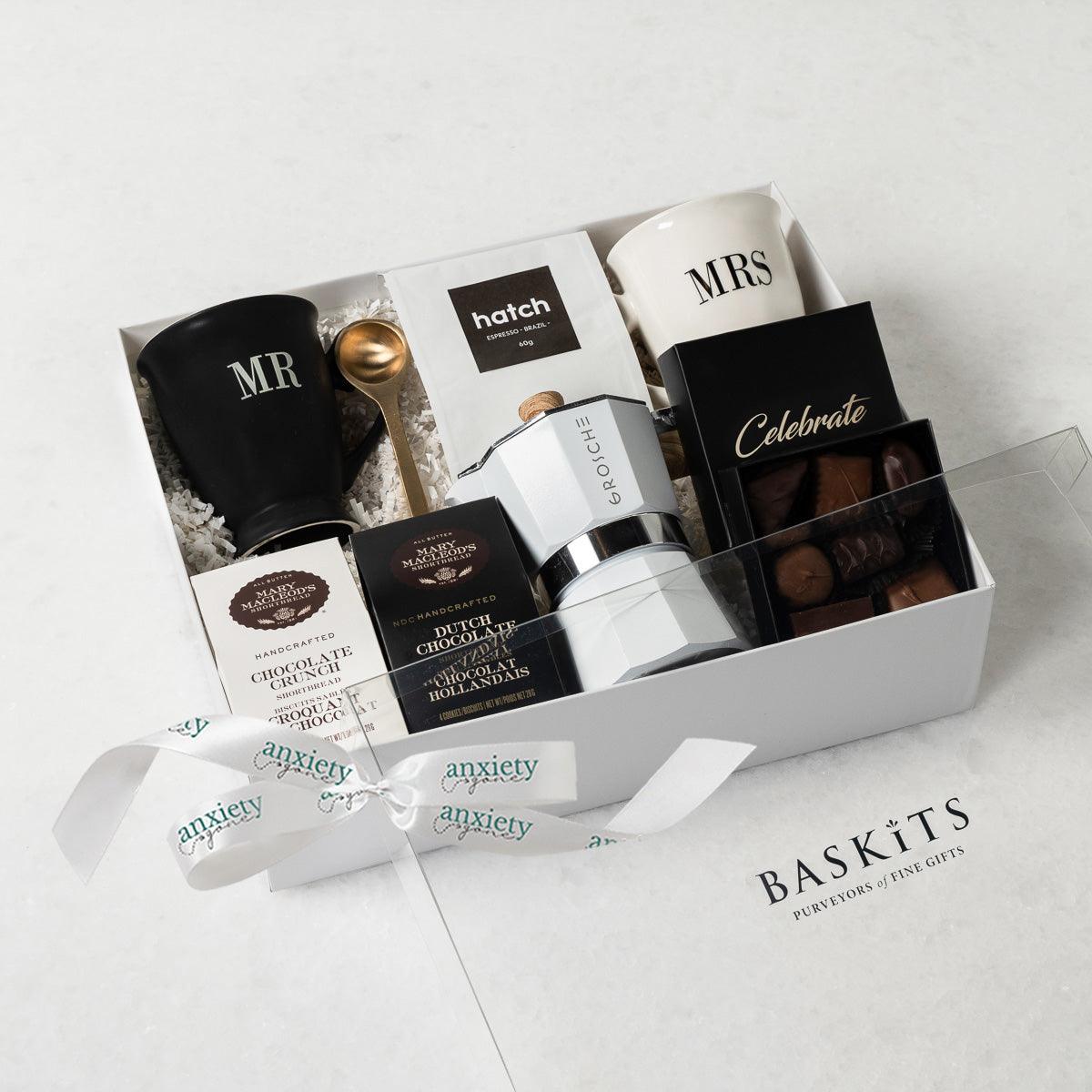Celebrate Love Gift Box featuring self-care items like Mr. & Mrs. mugs, espresso coffee maker, gourmet treats, and more—ideal for engagement gifts, anniversary presents, thank you gift baskets, and self-care gift baskets.