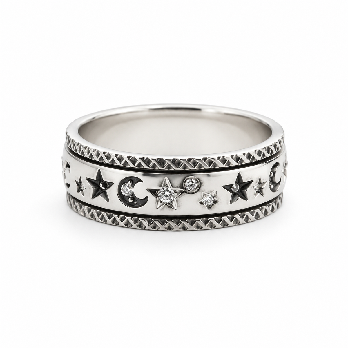 A silver celestial band  fidget ring featuring stars, crescent moons, and small clear gemstones, set against a plain white background.