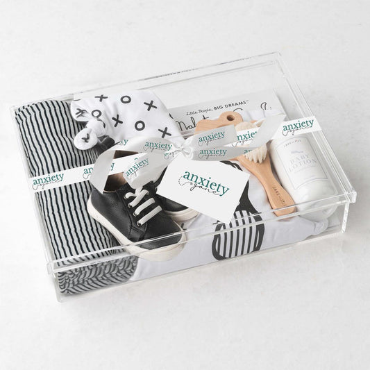 Baby boy gift basket with swaddle, onesie, shoes, and teether is a Stylish newborn gift set for boys with clothing and keepsakes
