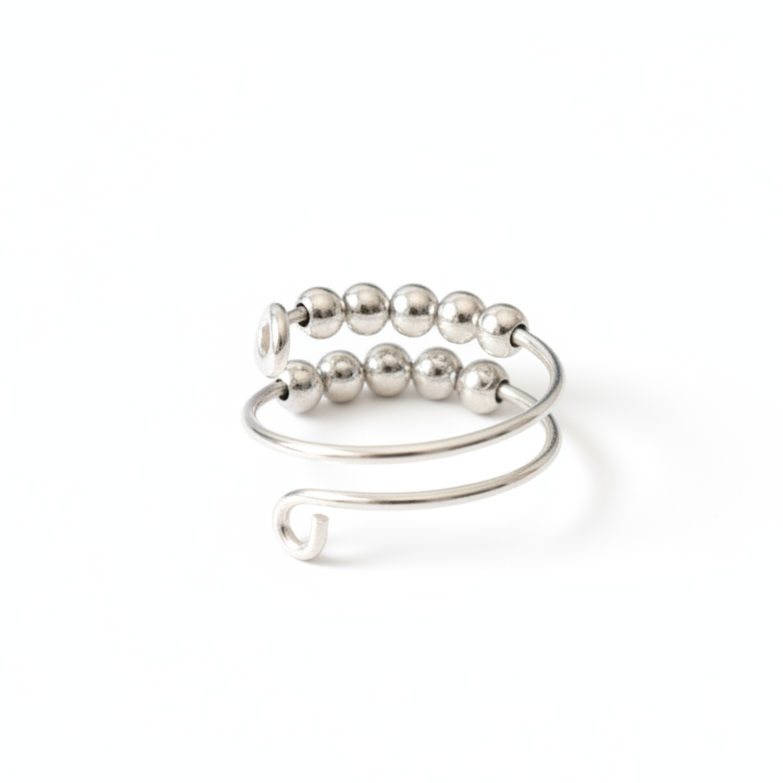 Silver fidget ring with beads on a light gray background