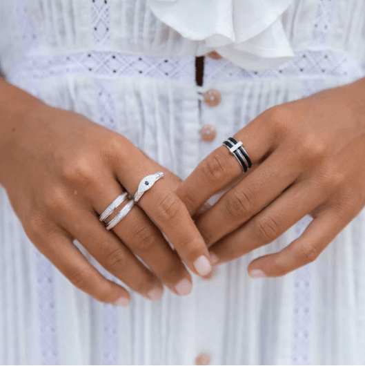 Sterling Silver Anxiety Ring with black enamel spinning bands, encrusted with silver and CZ accents, displayed with complimentary Travel Pouch and Tin"
