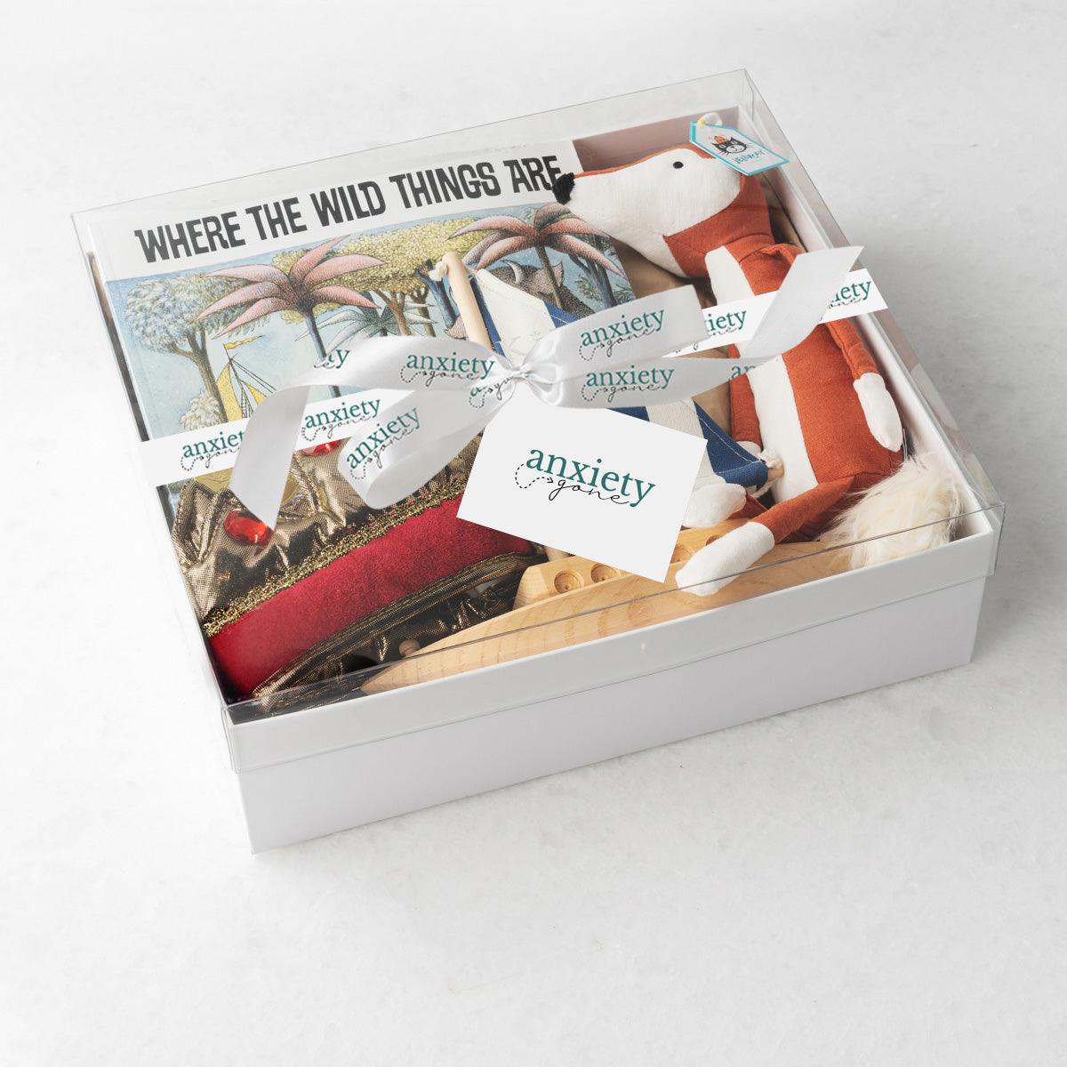 Where the Wild Things Are Gift Basket – Unique baby gift basket with wooden sailboat, gender-neutral crown, Jellycat fox plush, classic children's book, and keepsake box. Ideal for baby showers, new baby gift baskets, personalized baby gifts, and baby boy or girl gift ideas. Perfect for inspiring imagination and childhood adventures.