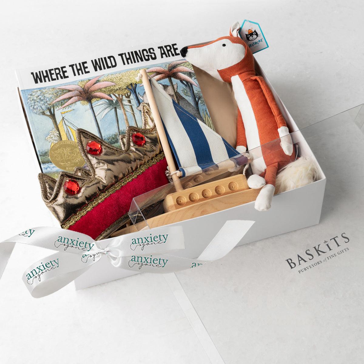 Where the Wild Things Are Gift Basket – Unique baby gift basket with wooden sailboat, gender-neutral crown, Jellycat fox plush, classic children's book, and keepsake box. Ideal for baby showers, new baby gift baskets, personalized baby gifts, and baby boy or girl gift ideas. Perfect for inspiring imagination and childhood adventures.