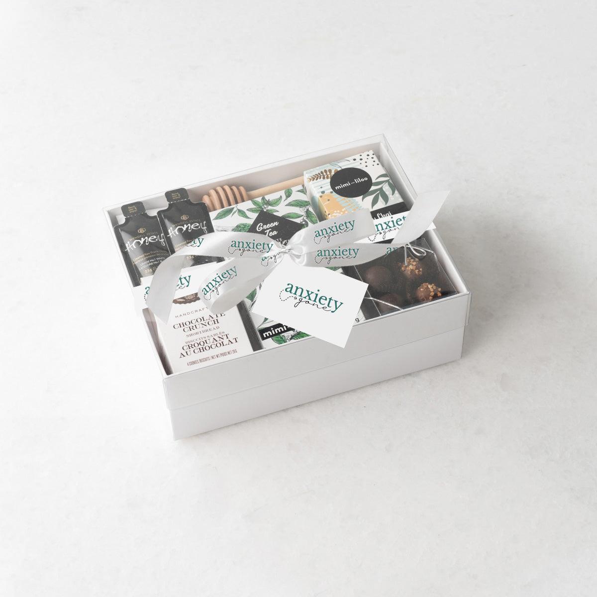 Just Tea & Me Wellness Gift Box – A beautifully curated tea gift box featuring chai tea, cookies, chocolate, and honey for the ultimate self-care experience in a food gift basket. 

