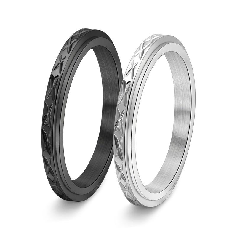 Dainty anxiety ring in silver and black with faceted spinning band on white background