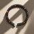 Tiger's Eye Leather Bracelet with braided black leather for mental clarity and emotional strength.