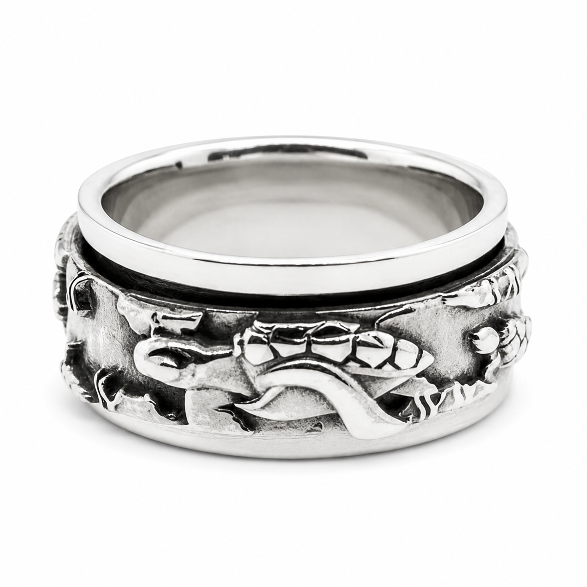 A sterling silver spinner ring featuring an embossed design of sea turtles and marine life on the band, shown on a clean white background.