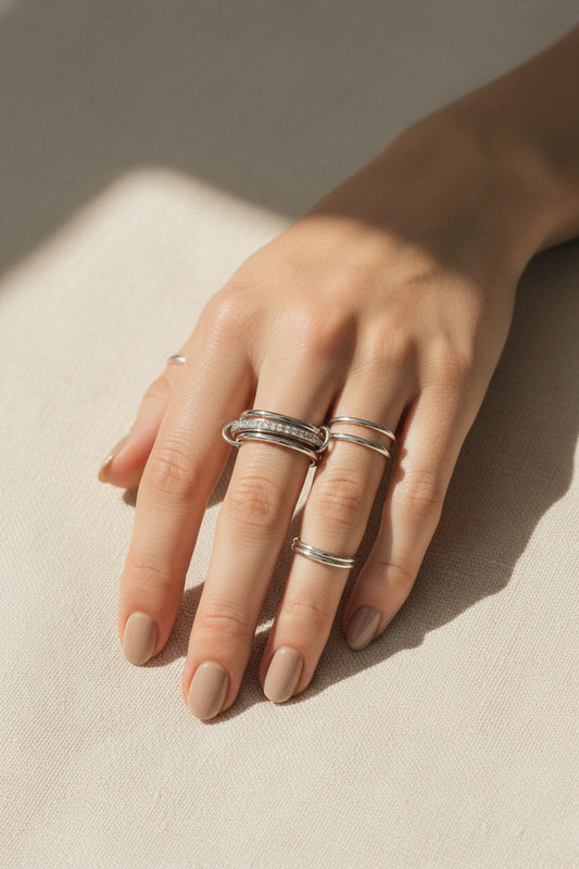 Silver ring with small diamonds on a white background