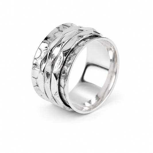 A silver spinner ring with a textured, overlapping band design, shown on a clean white background.