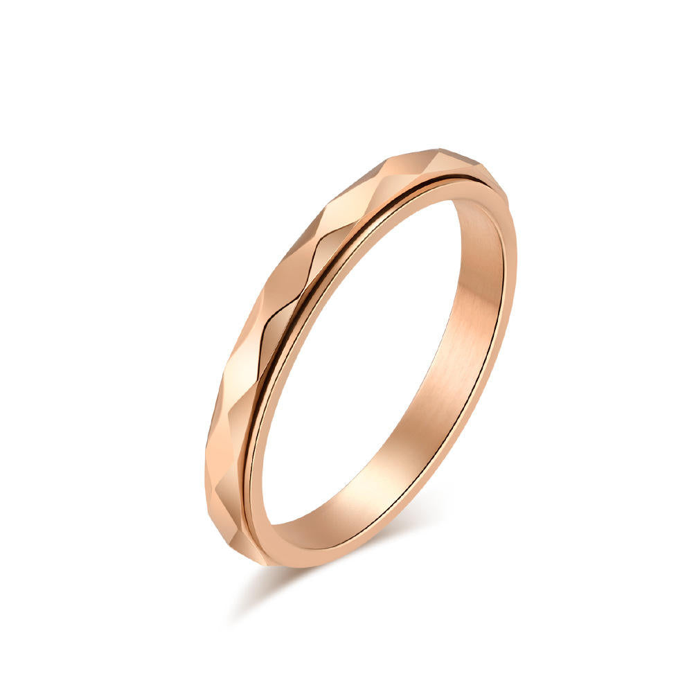 Rose gold Calm Wave spinner ring with faceted wave detail and visible rotating band