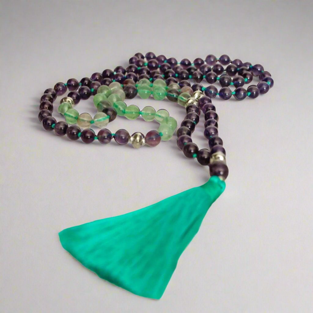 Awaken Amethyst and Green Fluorite Mala Necklace with 108 beads for spiritual healing and anxiety relief.