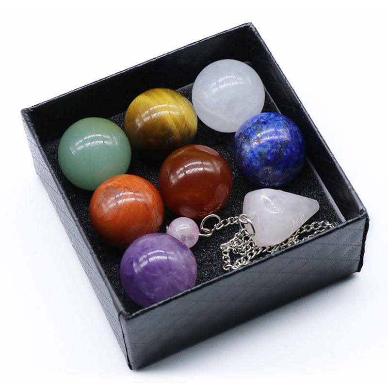 Chakra Gemstone Sphere Crystal Box Set with 7 chakra stones, rose quartz pendulum, and chakra balancing booklet.