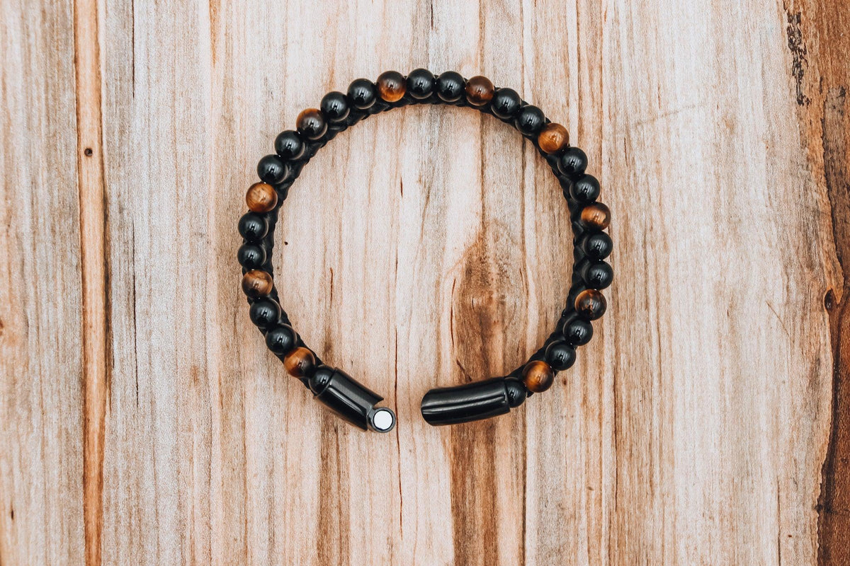 Tiger&#39;s Eye Leather Bracelet with braided black leather for mental clarity and emotional strength.