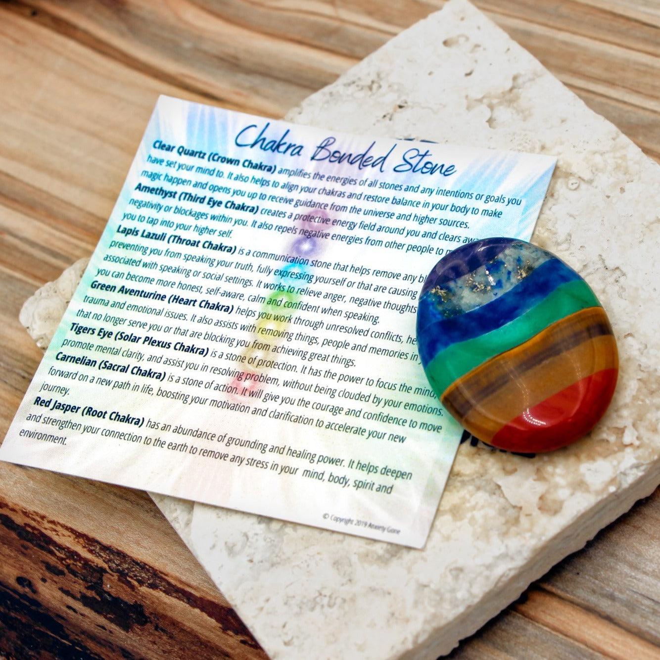 7 Chakra Bonded Worry Stone with thumb indentation for stress relief and chakra healing, using stones for anxiety.