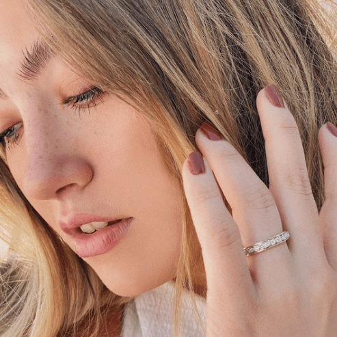 Devotion Meditation Anxiety Ring in high-quality sterling silver with oval and marquise spinning band adorned with clear CZ stones, displayed with complimentary tin